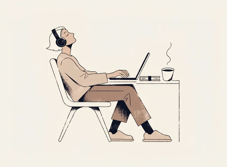 Person at a laptop with headphones, listening while working